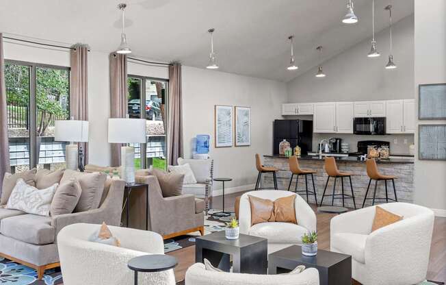 A modern living room with a kitchen in the background.