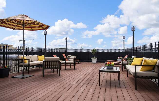 a deck with chairs and umbrellas on top of a roof