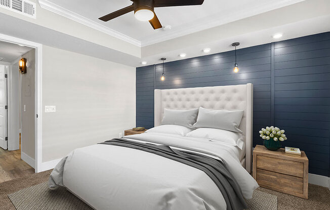 Carpeted bedroom with ceiling fan and textured shiplap accent wall.