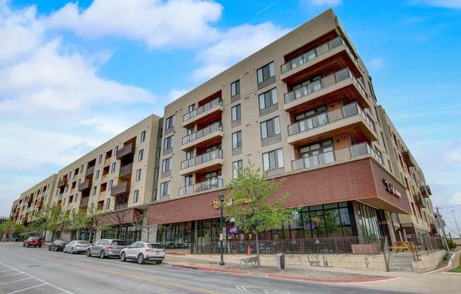 a large apartment building on the corner of a city street