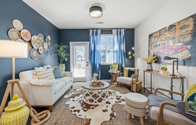 a living room with blue walls and a white couch