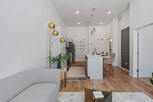 a living room and dining room with a couch and a table at SevenO2 Main Apartments, Salt Lake City, 84101