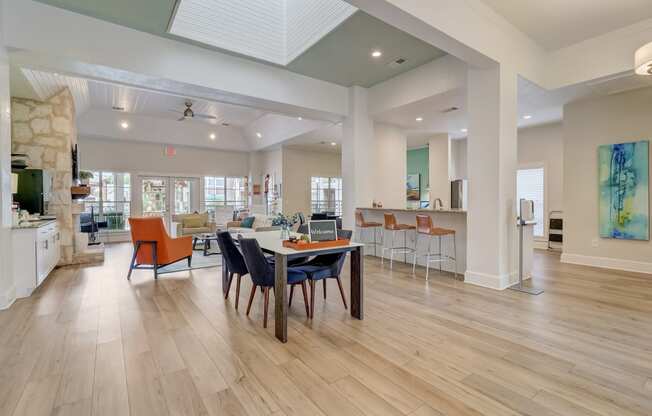 a dining room with a table and chairs in the center