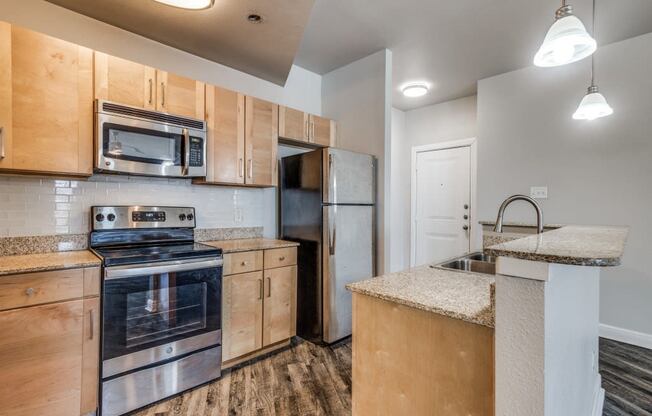 a kitchen with wooden cabinets and stainless steel appliances
