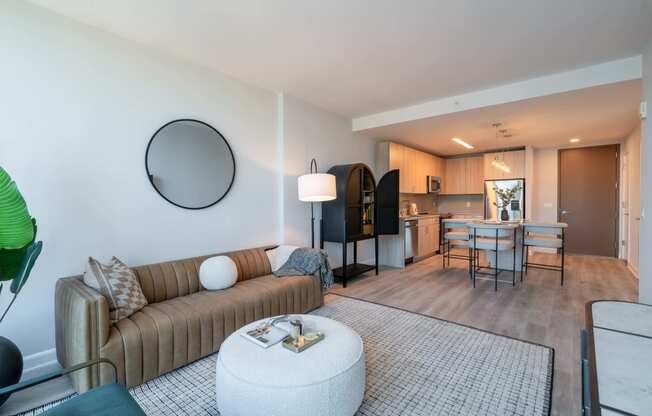 a living room with a couch and a table and a kitchen