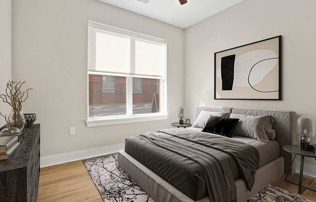 A bedroom with a large bed and a window.