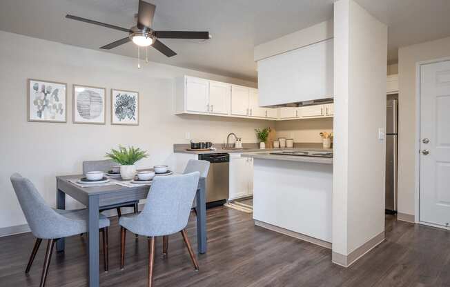 an open kitchen and dining room with a blue table and chairs