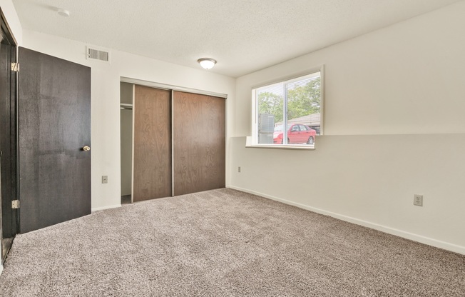 A room with a car parked outside the window.