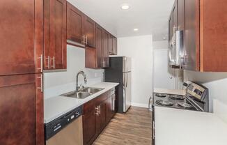 a kitchen with stainless steel appliances and wooden cabinets