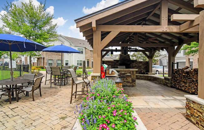 a patio with tables and chairs and a pavilion