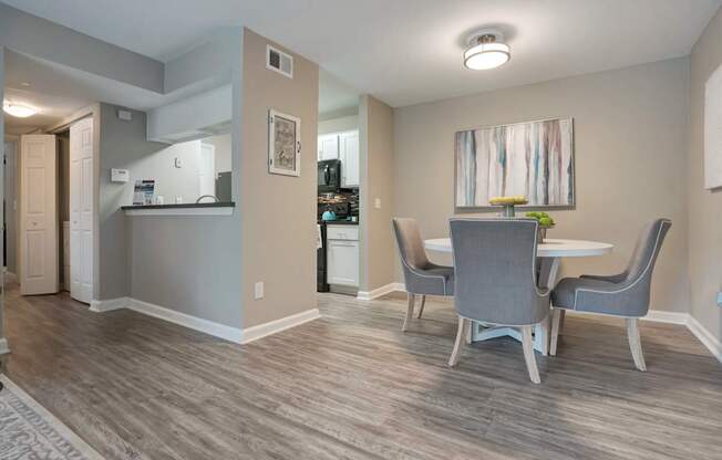 A dining room with a table and chairs.