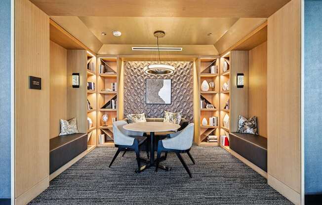 A modern dining room with a round table and chairs.