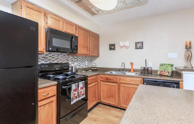 a modern kitchen with stainless steel appliances and wooden cabinets