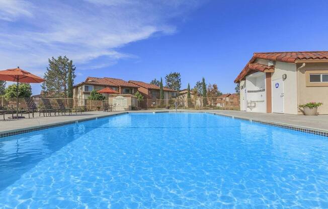a swimming pool with buildings in the background at Riverview Springs, Oceanside, California