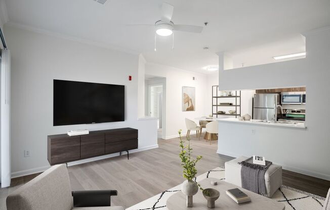 a living room with a large tv and a table