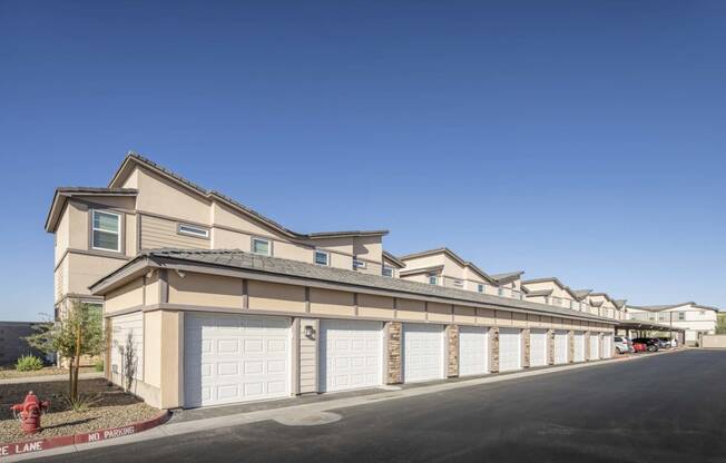 a row of houses with garages and a fire hydrant at Grandstone at Sunrise, Peoria, AZ