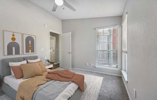 a bedroom with a bed and a ceiling fan