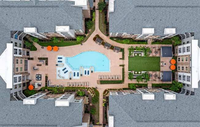 a birds eye view of a building with a swimming pool