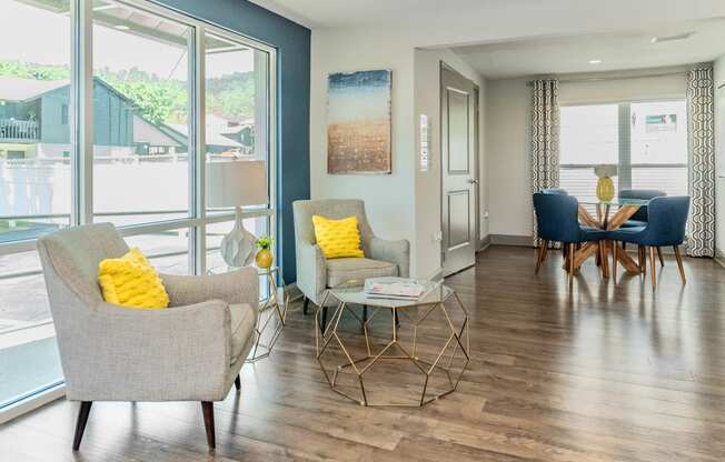 a living room with chairs and a table