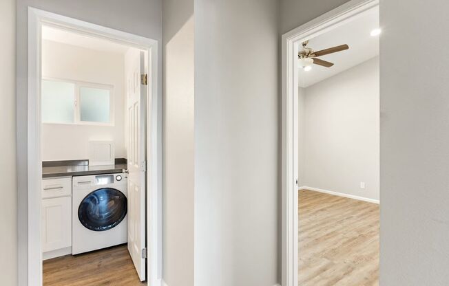 a white laundry room with a washer and dryer in it