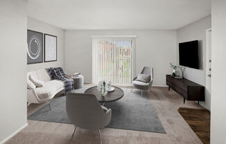 Model apartment living room with a couch and a table