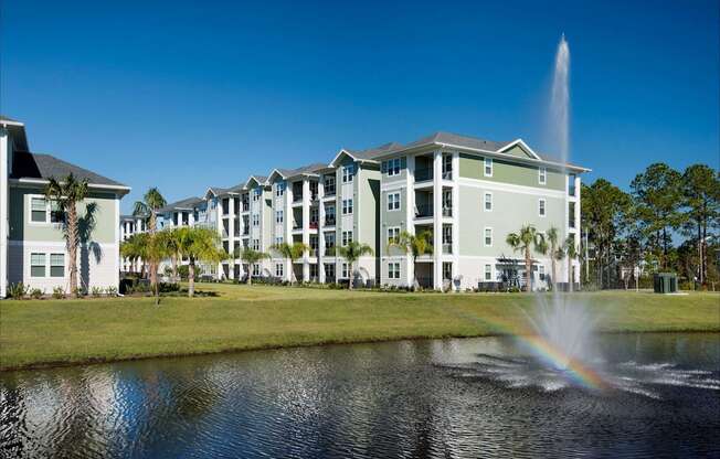 A building with a fountain in front of it.