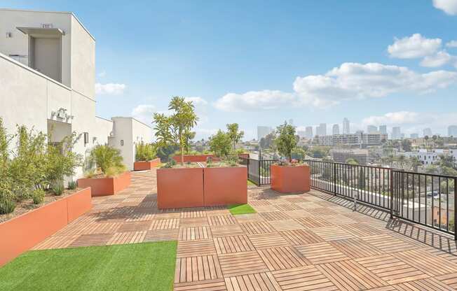 a roof terrace with a view of the city