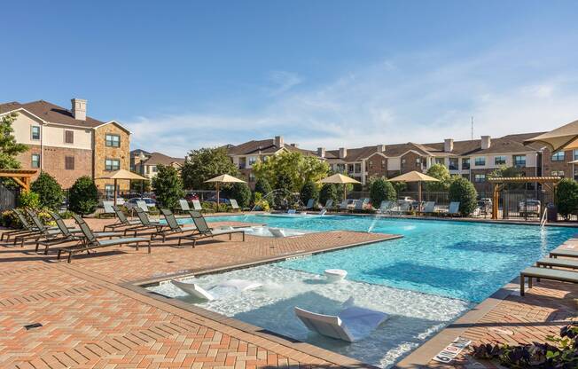 Refreshing salt water swimming pool with sundeck at Avenues at Craig Ranch apartments for rent in Dallas
