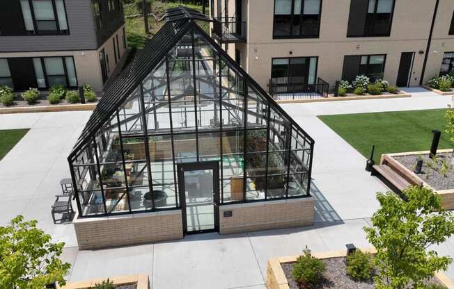 an aerial view of a greenhouse on the side of a building