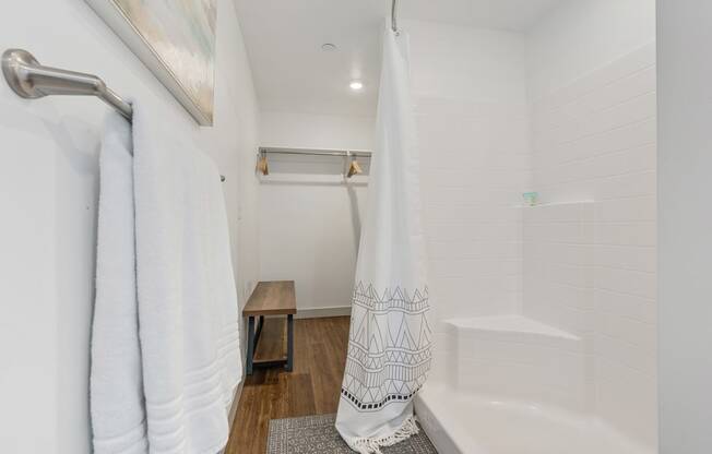 a bathroom with a shower and a tub and a shower curtain