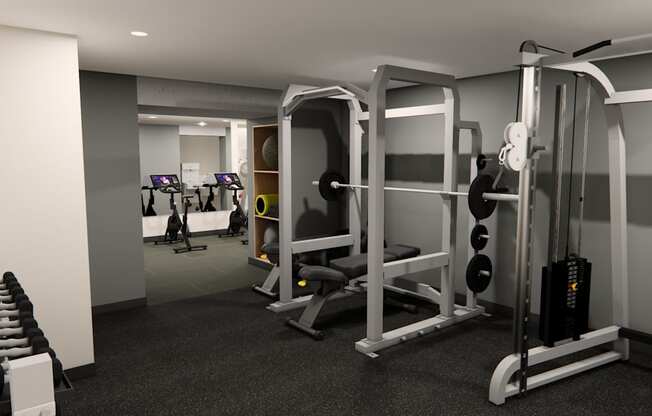 A black and white photo of a gym with a variety of equipment.