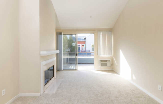 Carpeted Living Room with Fireplace and Balcony