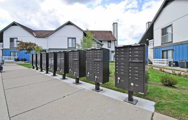 a row of mailboxes on a sidewalk in front of houses