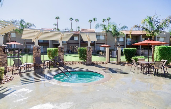 a swimming pool at a resort with tables and umbrellas