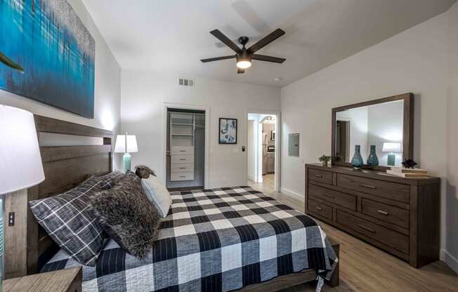 a bedroom with a bed and a ceiling fan