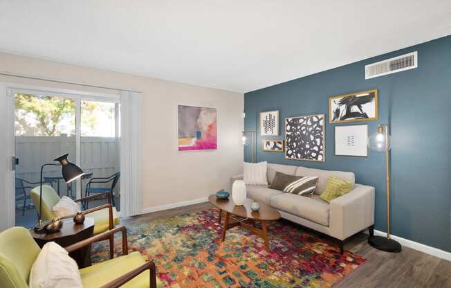 a living room with a couch and a chair and a window