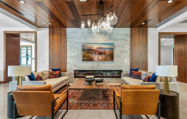 a living room with couches and chairs and a fireplace at The Colony, Charlotte, NC