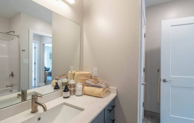 a bathroom with a large mirror and a sink and a shower at Edgebrook Residences, Merrimack, NH 03054