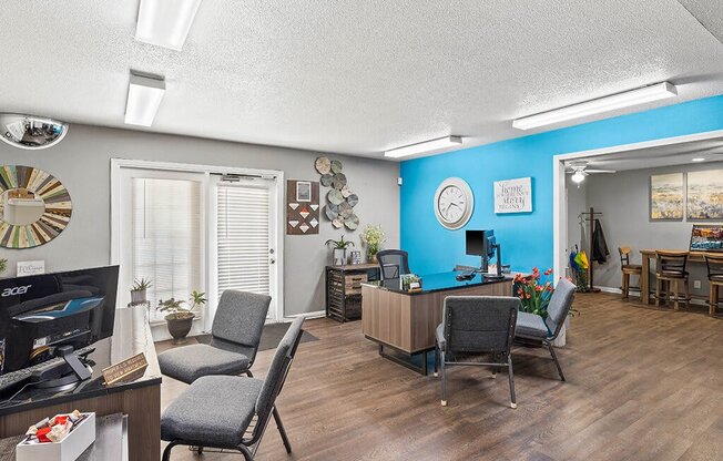 a living room and dining room with a desk and a tv