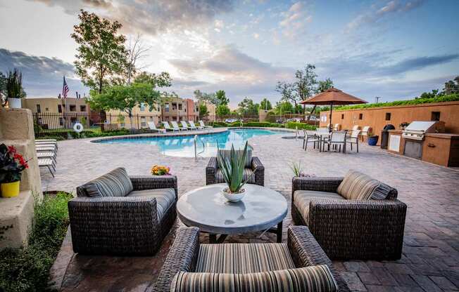 Lounge Area on Pool Deck with Cushion Chairs at Rancho Carrera Apartments NM