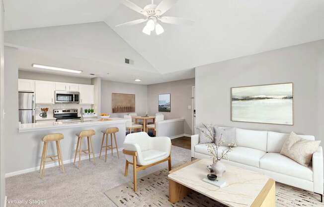 A living room with a white couch and a wooden coffee table.
