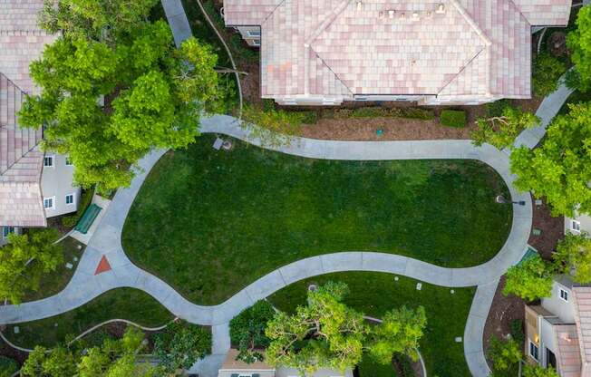 A park with a winding path and a red triangle marker.