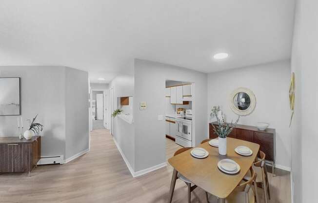 a dining room and kitchen with a table and chairs