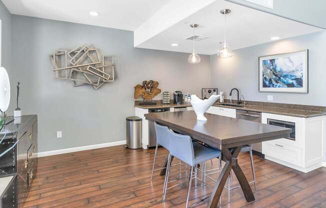 A modern kitchen with a wooden table and chairs.
