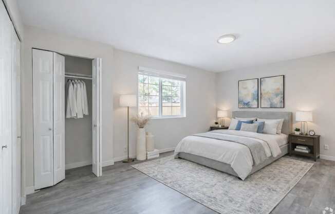 A bedroom with a large bed and a window.