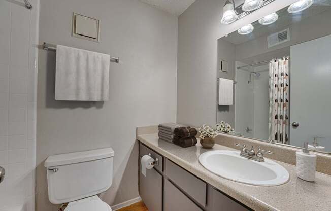 A white toilet is next to a sink in a bathroom.