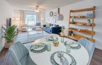 A dining room with a white table set for six.