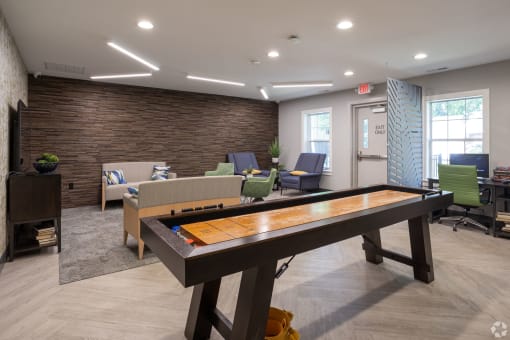 a game room with a foosball table and a couch
