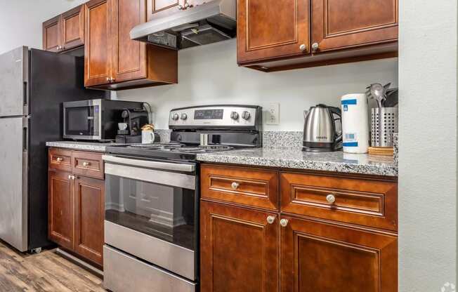 a kitchen with stainless steel appliances and wooden cabinets