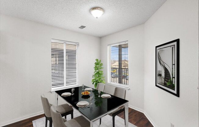 our apartments offer a dining room with a black table and chairs